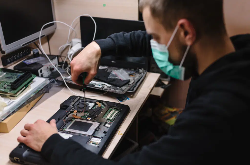 Technician performing onsite computer repair